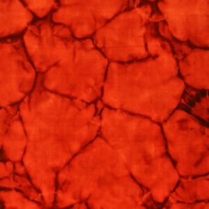 Plush reddish-orange rug with an abstract, high-contrast dark crackle or spiderweb pattern.