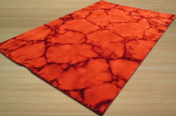 Orange and dark red rug with an abstract cracked pattern on light plank wood flooring.