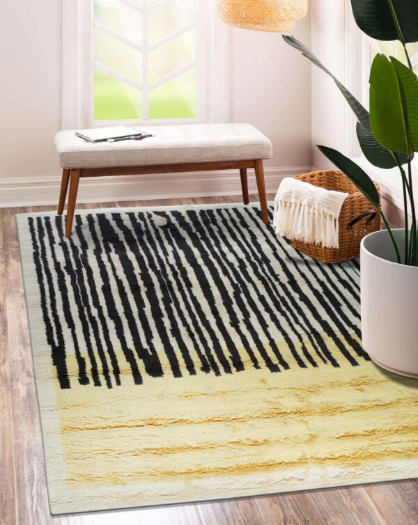 High-pile rug featuring black stripes over white, transitioning to solid shaggy yellow, on wood flooring.