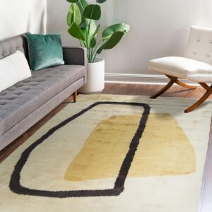 Shaggy cream rug with thick dark outline and abstract gold shape in a contemporary room.