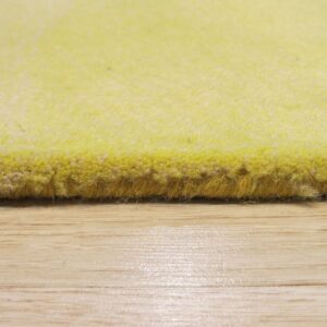 The edge of a bright yellow high-pile rug rests on a shiny, light wood floor surface.