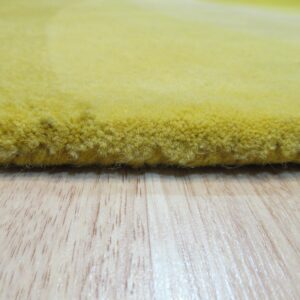 The thick, bright yellow plush rug rests on light wood grain flooring.
