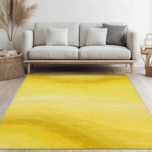 Abstract yellow and gold shaded rug on light flooring under a minimal white sofa.
