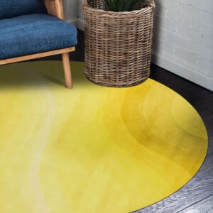 Bright yellow circular rug on dark wood, next to a blue chair and woven basket.