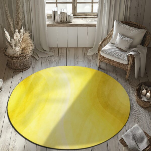 Circular yellow rug with abstract gradient bands sits on light wood planks next to a rattan chair.