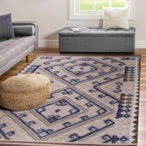 Blue, beige, and brown geometric rug anchors a living room with wood floors and gray upholstered furniture.