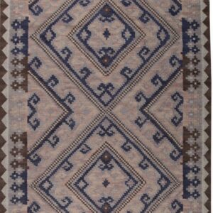 Flatwoven rug in beige, navy blue, and brown with large central geometric diamond designs.