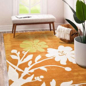 Orange rug with cream and yellow floral pattern beneath a light gray upholstered window bench.