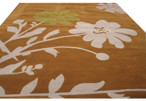 Medium pile rug in deep gold features large, stylized floral and vine patterns in off-white and pale green.