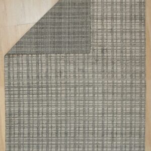 Light gray rug with a raised dark gray grid pattern rests on blonde wood flooring.