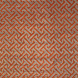 Plush gray rug featuring a raised orange interlocking geometric pattern.