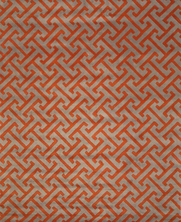 Plush gray rug featuring a raised orange interlocking geometric pattern.
