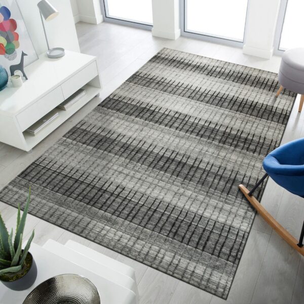 Textured gray rug with alternating dark and light striped bands rests on light wood flooring.