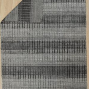 Gray textured rug featuring horizontal stripes and a vertical grid pattern covers light-colored plank flooring.