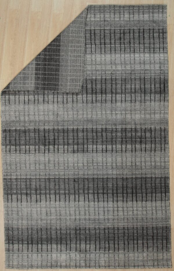 Gray textured rug featuring horizontal stripes and a vertical grid pattern covers light-colored plank flooring.
