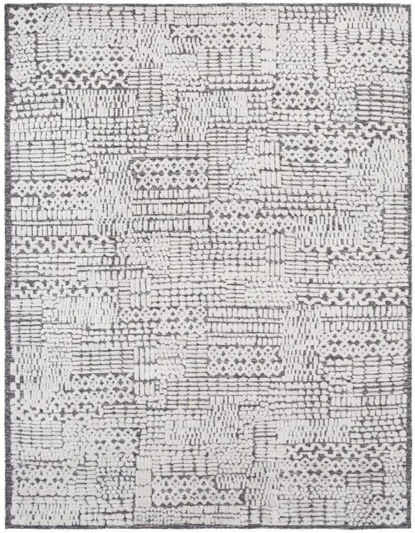 Textured white and charcoal gray rug with abstract high-low pile geometric block patterning.