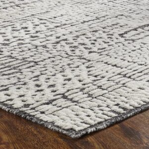 Textured cream and dark gray rug featuring a raised geometric pattern on wood flooring.