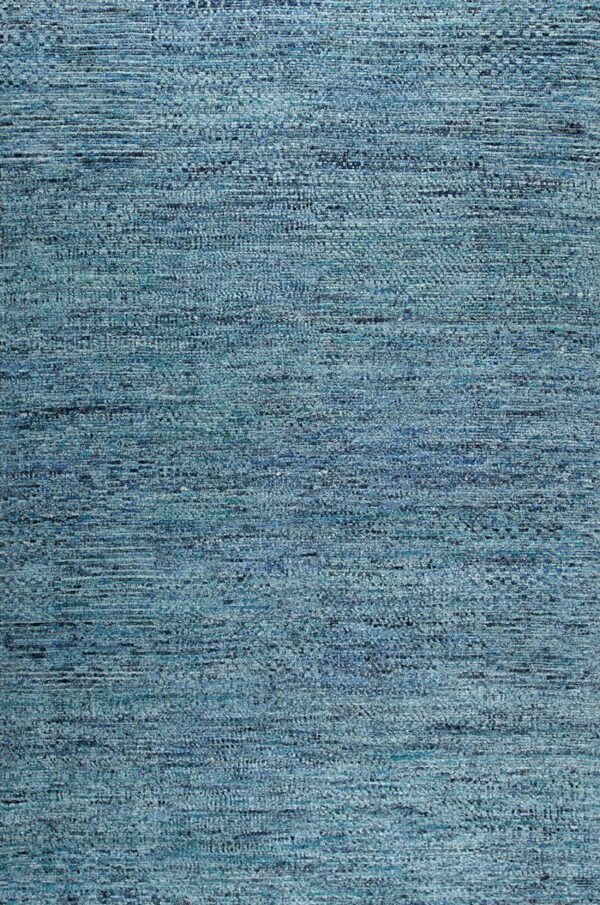 Textured rug in variegated blues and teals, featuring horizontal tonal banding across the low pile surface.