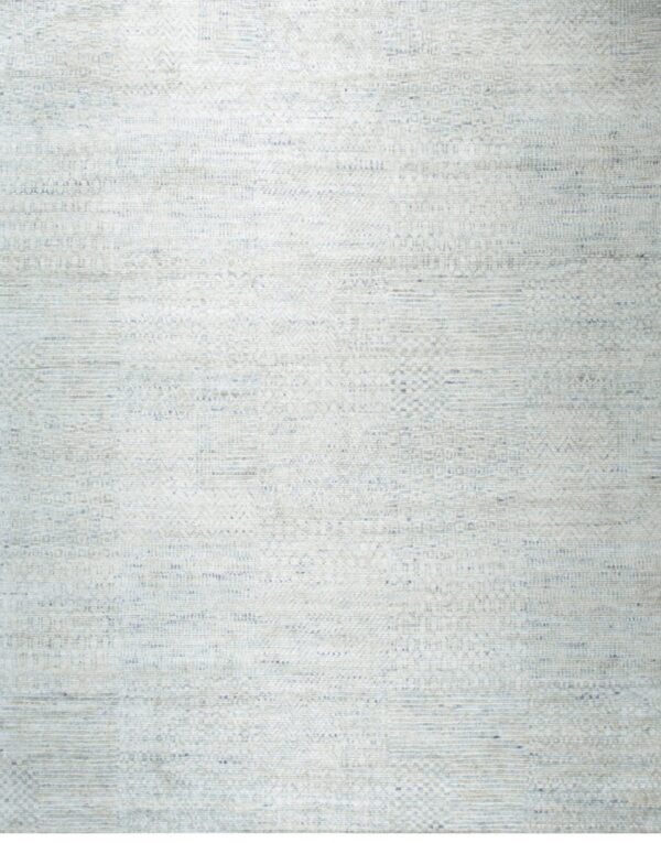 Low-pile rug featuring a complex, striated texture and geometric accents in off-white and pale blue.