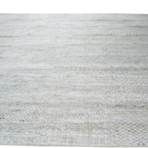 Textured, low-pile rug in light gray and beige with subtle horizontal striping and blue accents.
