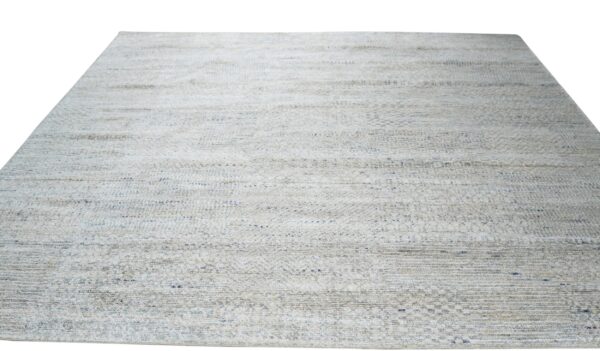 Textured, low-pile rug in light gray and beige with subtle horizontal striping and blue accents.