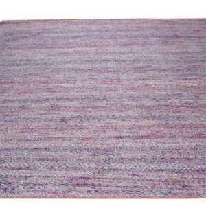 Low-pile rug displaying variegated horizontal stripes blending pink, dusty blue, and beige against a white background.