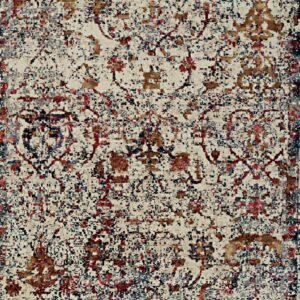Distressed traditional rug in cream, navy, red, gray, and gold with a mottled, pixelated effect.