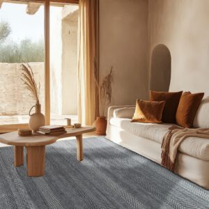 A gray and white textured chevron rug anchors a rustic living room with a white sofa and wood beams.
