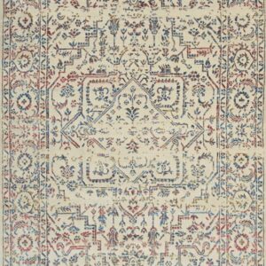 Distressed traditional rug in cream, blue, and red featuring a medallion design and short fringe.