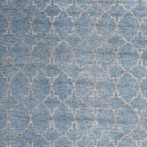 Textured blue area rug displaying a repeating light tan quatrefoil geometric pattern.