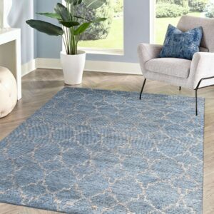 Blue rug with light beige geometric lattice pattern on light wood herringbone flooring.