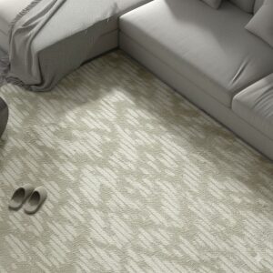Low-pile beige rug with a diagonal dash pattern sits beneath a light gray sectional sofa.