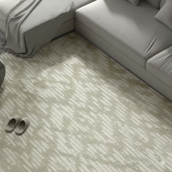 Low-pile beige rug with a diagonal dash pattern sits beneath a light gray sectional sofa.