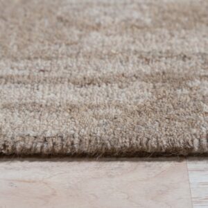 Textured beige rug with subtle horizontal stripes rests on light wood plank flooring.
