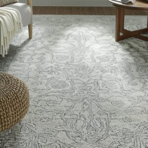 Textured light gray rug featuring a detailed dark gray traditional scrolling pattern in a living space.