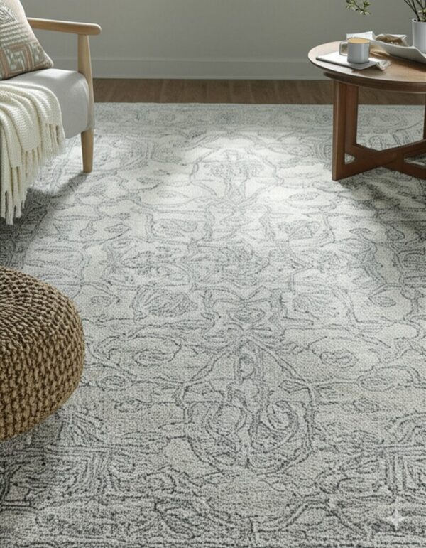 Textured light gray rug featuring a detailed dark gray traditional scrolling pattern in a living space.