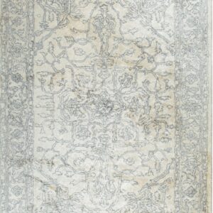 Elegant beige rug with intricate patterns.