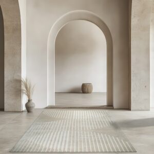 Pale beige striped runner rug in a minimalist room with large archways and textured walls.