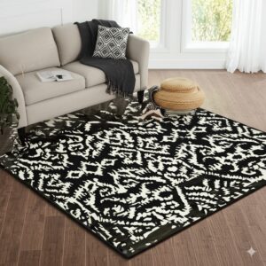 Glossy black and white abstract rug placed under a neutral sofa on brown plank flooring.