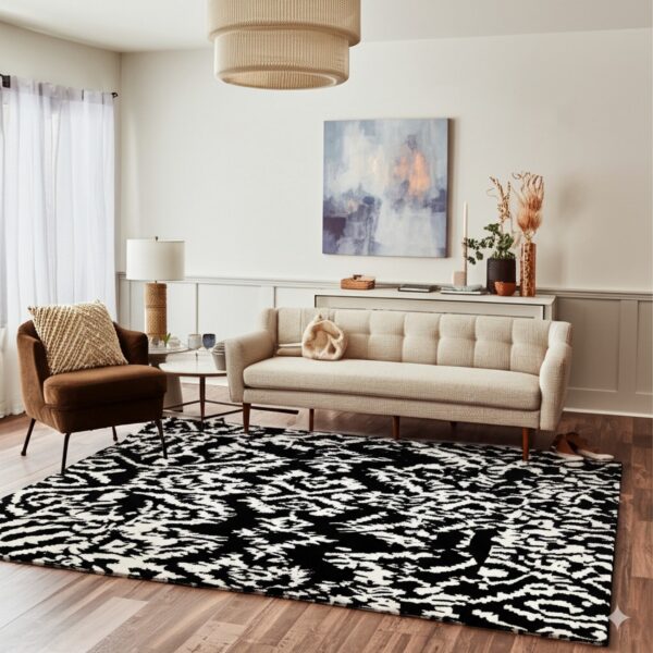 High-contrast black and white textured rug beneath a beige sofa and brown armchair on wood flooring.