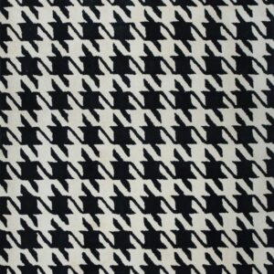 Full view of a low-pile rug with a high-contrast black and off-white houndstooth design.