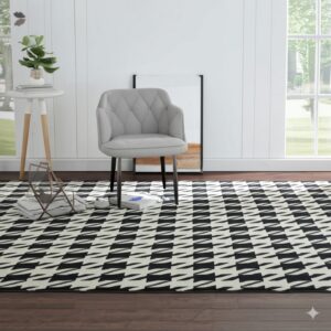 Black and off-white abstract pattern rug layered on dark wood flooring under a tufted gray chair.