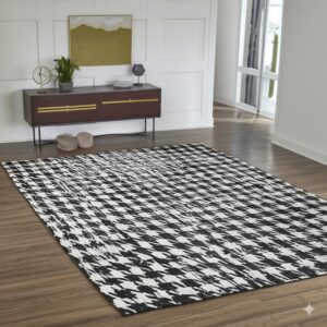 Black and white rug with a distressed houndstooth pattern lays on brown wood plank flooring.