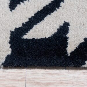 Dense black and cream high-pile rug with an irregular pattern rests on light wooden plank flooring.
