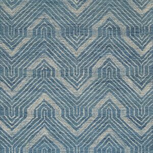 Textured blue and off-white rug featuring a repeating geometric zigzag and stepped pattern.