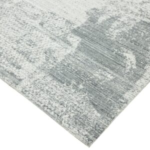 Gray and white rug with an abstract weathered design and mottled, textured low pile.