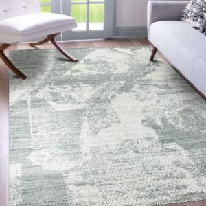 Light gray and white abstract rug on wood flooring between a white chair and gray sofa.