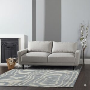 A low-pile blue and cream wave-patterned rug sits on a dark wood floor beneath a light gray sofa.