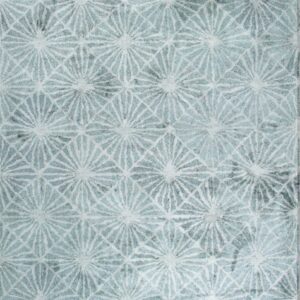 Textured, soft rug in aqua and white featuring a repeating geometric pattern of starbursts and grid lines.