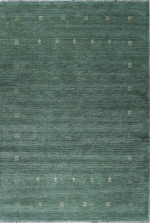 Teal green rug features visible abrash and repeating tan geometric and stylized tree motifs.